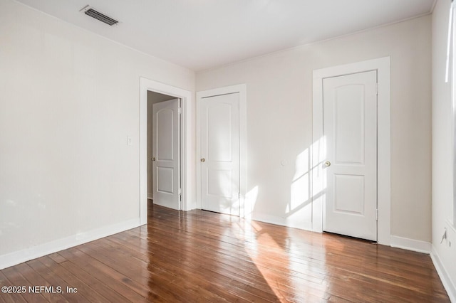 empty room featuring dark hardwood / wood-style flooring