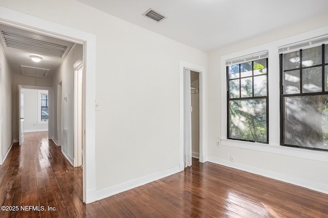 unfurnished room featuring dark wood-type flooring