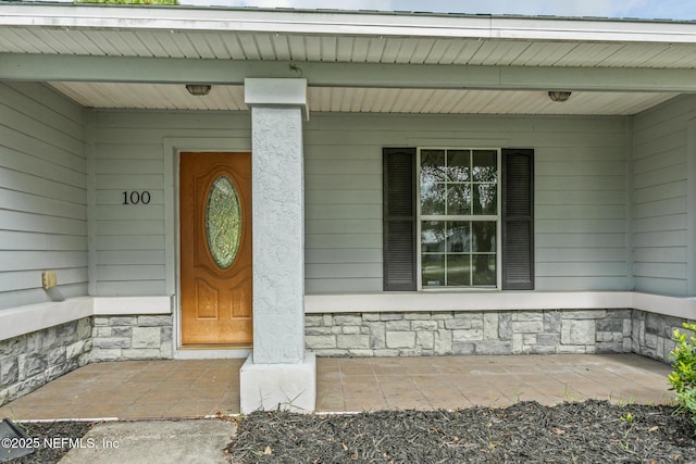 doorway to property with a porch