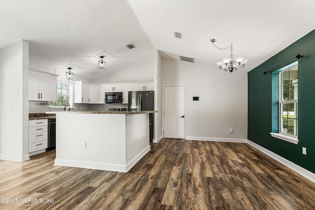 kitchen featuring lofted ceiling, decorative light fixtures, dark hardwood / wood-style flooring, a notable chandelier, and white cabinets