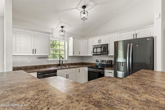 kitchen featuring vaulted ceiling, pendant lighting, sink, white cabinets, and stainless steel appliances