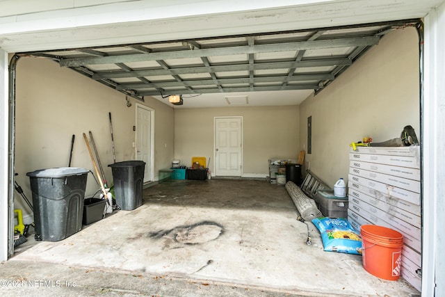 garage featuring a garage door opener and electric panel