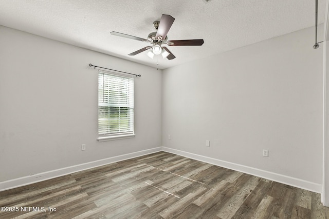 spare room featuring ceiling fan, a textured ceiling, and dark hardwood / wood-style flooring