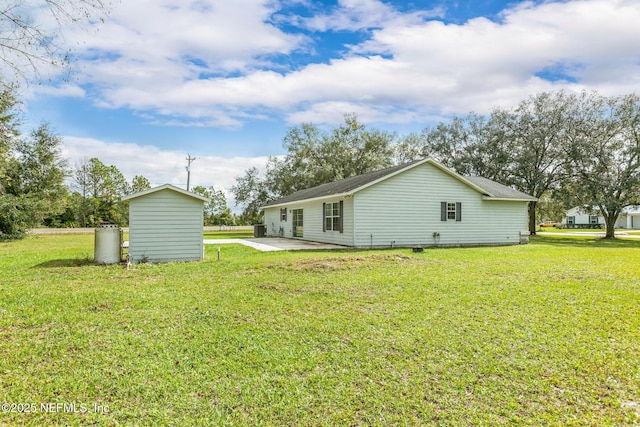 back of property featuring a yard and a patio area