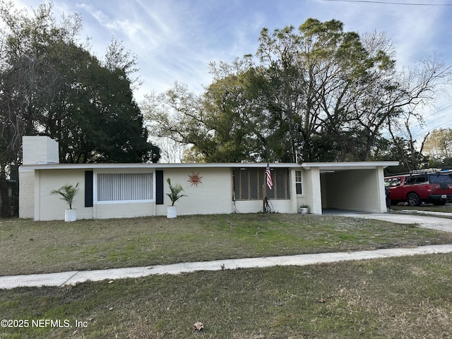 ranch-style house featuring a front yard and a carport