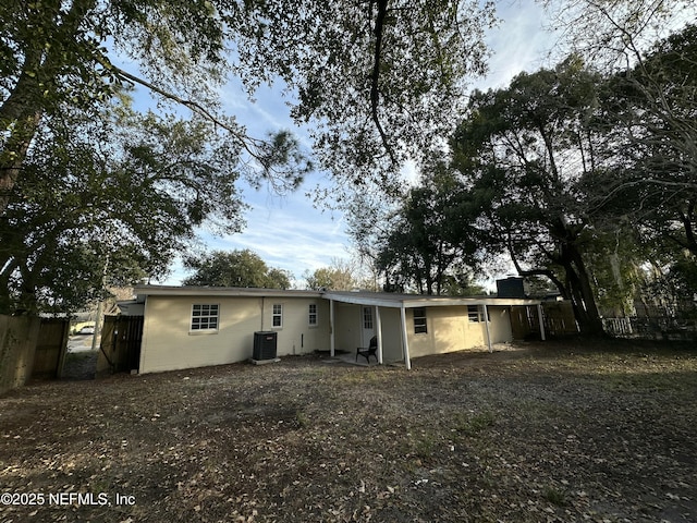 rear view of property with central AC unit