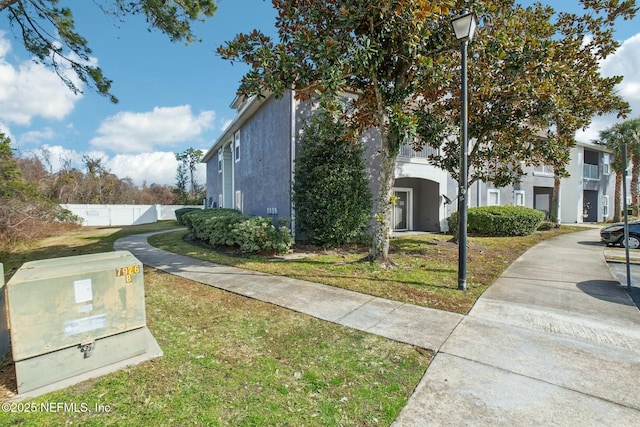 view of side of property featuring a lawn