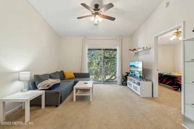 carpeted living room with ceiling fan