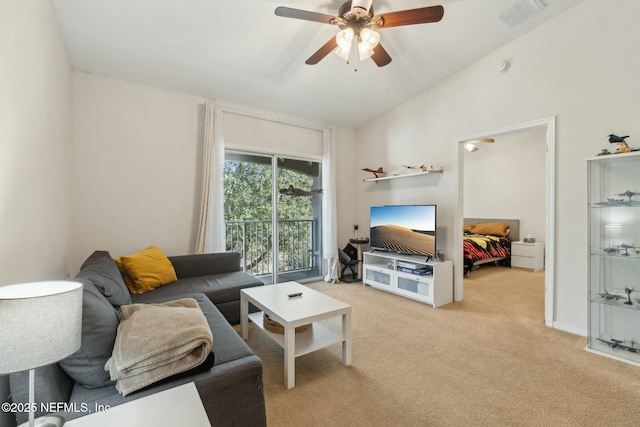 living room featuring ceiling fan, lofted ceiling, and light carpet