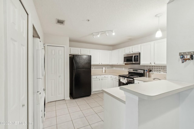 kitchen featuring pendant lighting, tasteful backsplash, white cabinets, kitchen peninsula, and stainless steel appliances