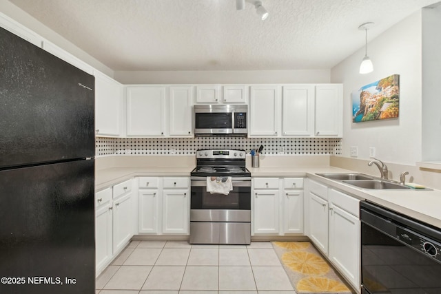 kitchen featuring light tile patterned flooring, pendant lighting, white cabinetry, sink, and black appliances