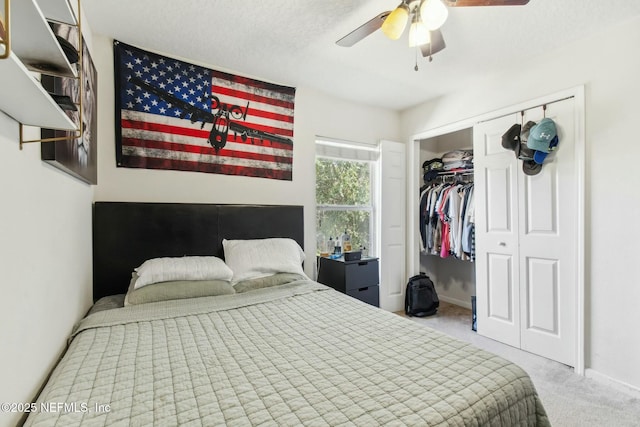 bedroom featuring light carpet, ceiling fan, and a closet