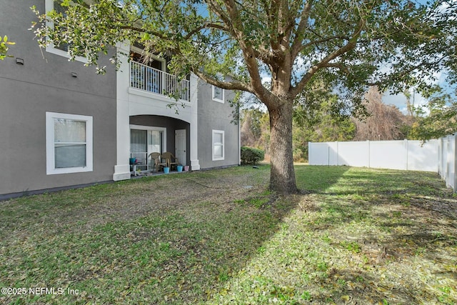 view of yard with a balcony