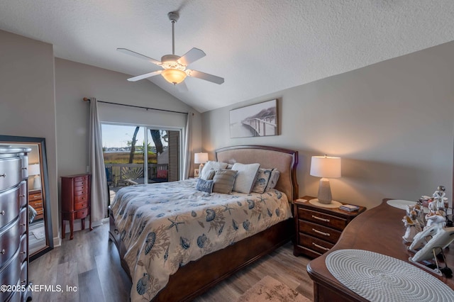 bedroom with vaulted ceiling, access to outside, ceiling fan, a textured ceiling, and light hardwood / wood-style flooring