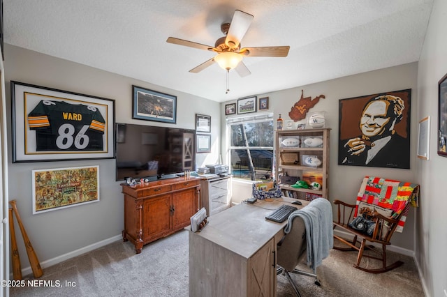 home office featuring ceiling fan, light colored carpet, and a textured ceiling