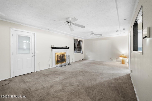 unfurnished living room with a tiled fireplace, carpet flooring, and a textured ceiling