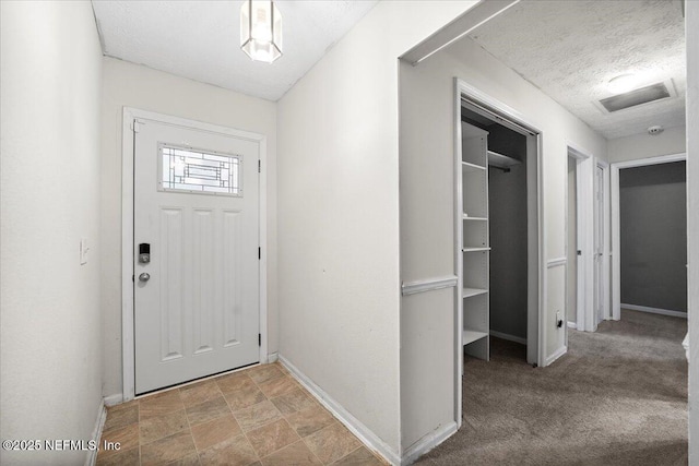 foyer entrance featuring a textured ceiling