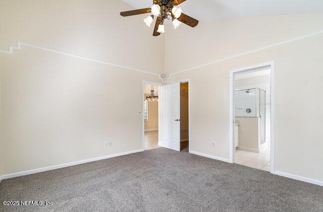 unfurnished bedroom featuring light carpet, connected bathroom, high vaulted ceiling, and ceiling fan