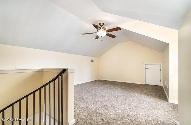 bonus room with vaulted ceiling and carpet flooring