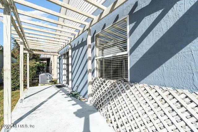 exterior space featuring a pergola, central AC, and a patio