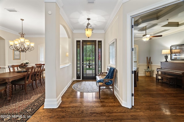 foyer entrance featuring an inviting chandelier, dark hardwood / wood-style flooring, ornamental molding, coffered ceiling, and beam ceiling