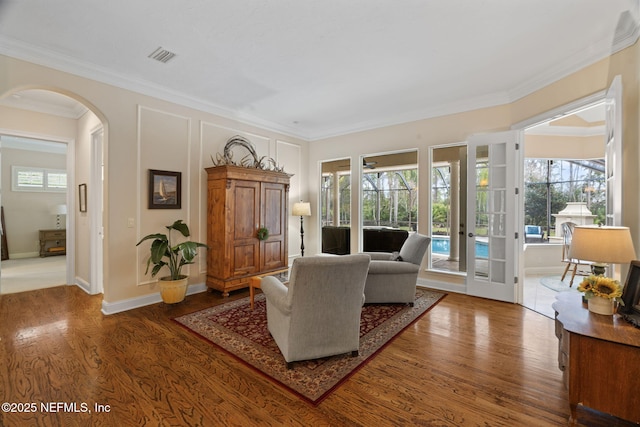 living room with ornamental molding and wood-type flooring