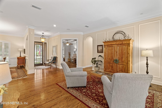 living room with crown molding and light hardwood / wood-style flooring