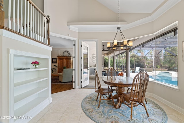 tiled dining room with crown molding and high vaulted ceiling