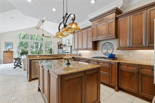 kitchen with appliances with stainless steel finishes, lofted ceiling with beams, decorative backsplash, hanging light fixtures, and a center island