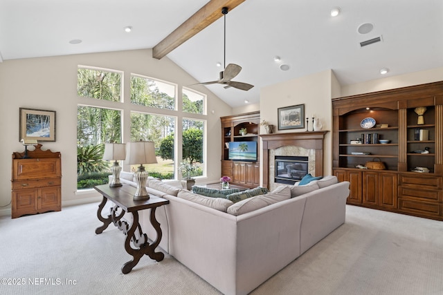 living room with a premium fireplace, high vaulted ceiling, light carpet, and beam ceiling