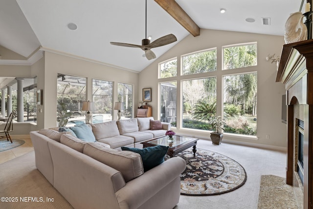 carpeted living room featuring beamed ceiling, ceiling fan, high vaulted ceiling, and ornate columns