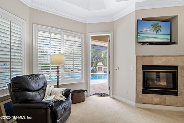 sitting room featuring crown molding, carpet, and a fireplace