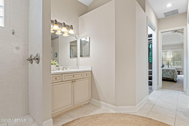 bathroom featuring vanity, tiled shower, and tile patterned floors