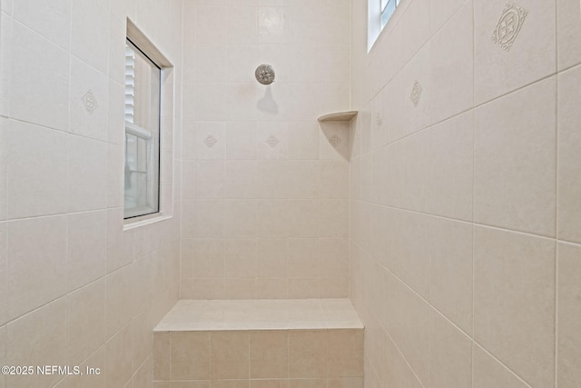 bathroom with a tile shower