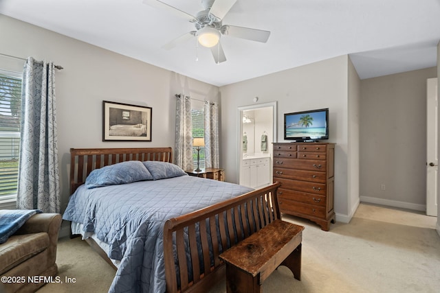 carpeted bedroom with ceiling fan and connected bathroom