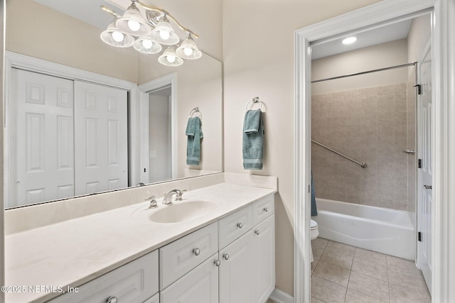 full bathroom featuring tile patterned floors, toilet, tiled shower / bath, vanity, and a notable chandelier