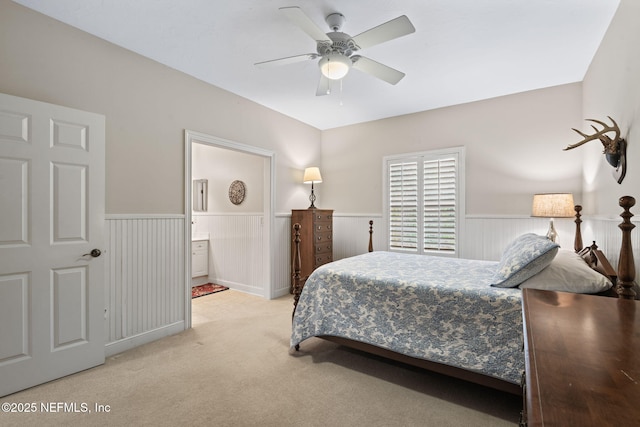 carpeted bedroom with connected bathroom and ceiling fan