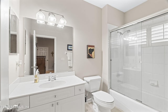 full bathroom featuring vanity, toilet, and combined bath / shower with glass door