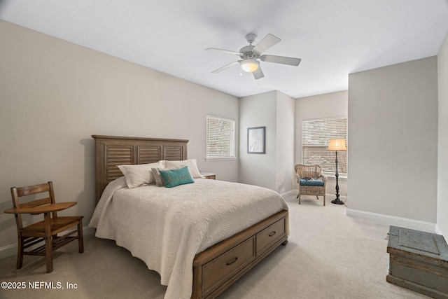 bedroom featuring light colored carpet and ceiling fan