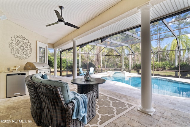 view of swimming pool with an outdoor kitchen, a lanai, area for grilling, and a patio