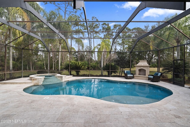 view of swimming pool featuring an in ground hot tub, exterior fireplace, a lanai, and a patio