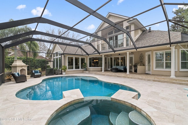 view of pool featuring a patio area, grilling area, glass enclosure, an in ground hot tub, and an outdoor living space with a fireplace