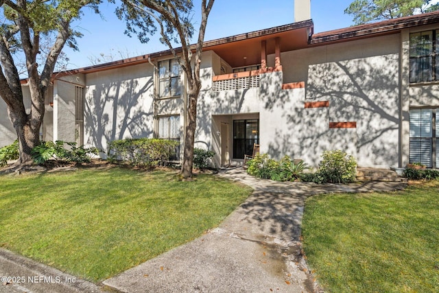 exterior space featuring a front yard and a balcony