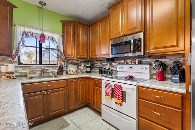 kitchen featuring electric stove, sink, pendant lighting, light tile patterned flooring, and decorative backsplash