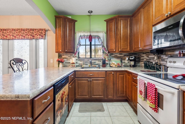 kitchen featuring dishwasher, sink, white electric range, and kitchen peninsula