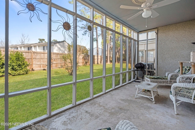 unfurnished sunroom featuring ceiling fan