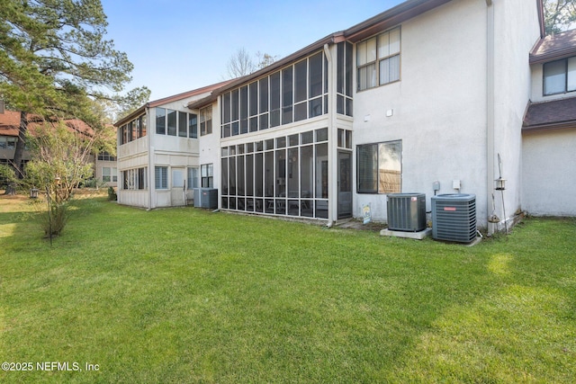 back of house with a yard and central air condition unit