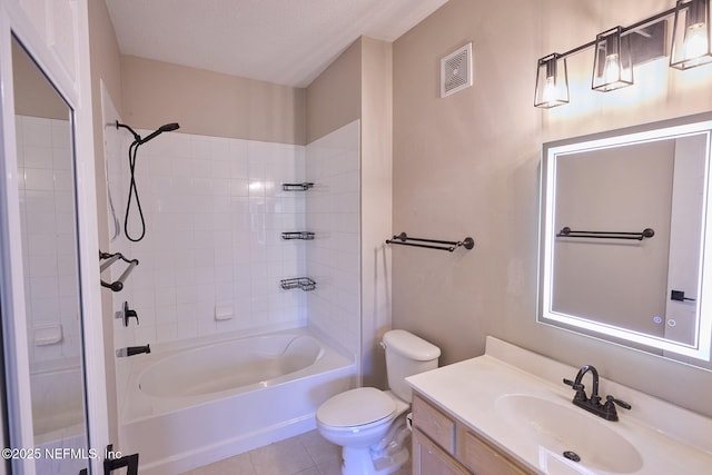 full bathroom with tiled shower / bath combo, vanity, toilet, tile patterned floors, and a textured ceiling