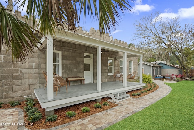 back of property with a wooden deck and a yard