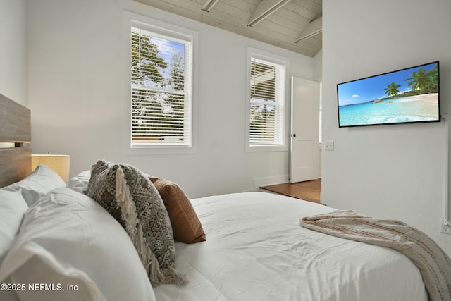 bedroom featuring vaulted ceiling with beams and wooden ceiling